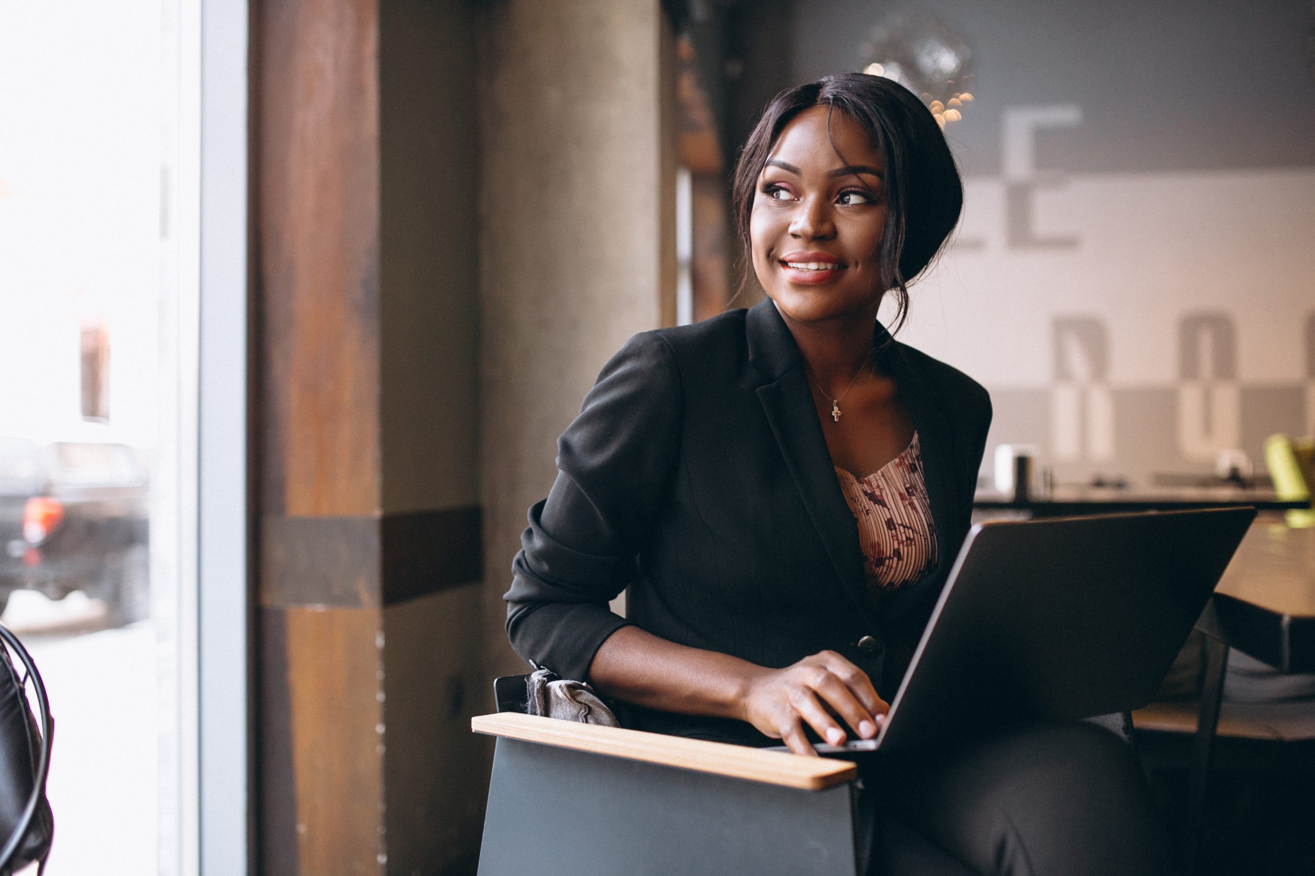 african american business woman working on a computer in a bar